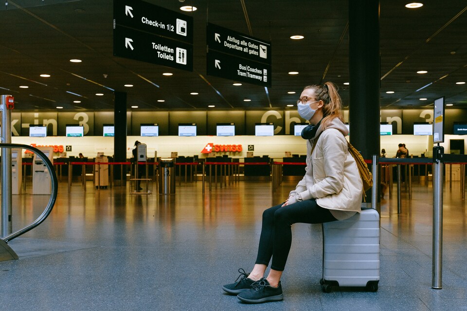 woman sitting on luggage 3943882 "Омикрон": в Европе возвращают карантин, по всему миру приостанавливают полеты