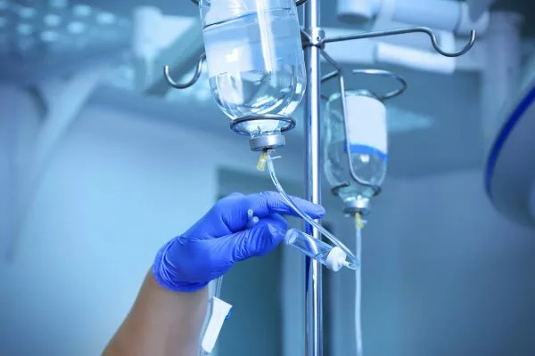 depositphotos_137595696-stock-photo-doctors-hand-and-infusion-drip